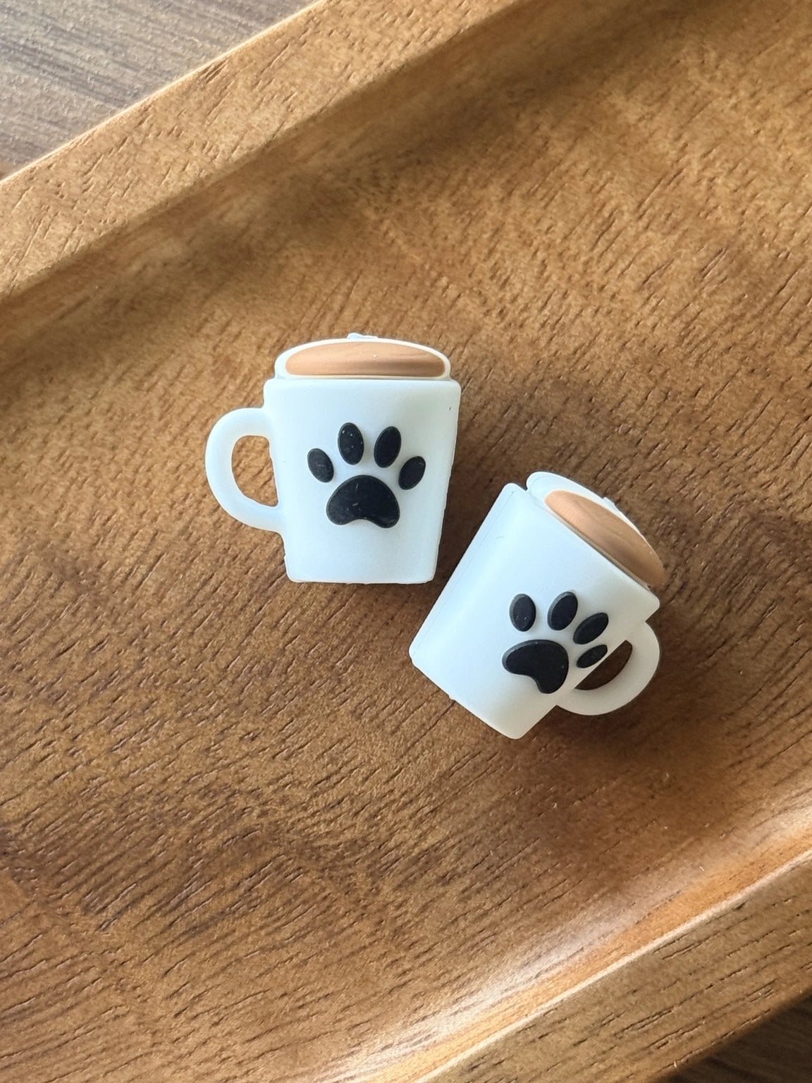 Paws & Coffee silicone focal bead shaped like a coffee mug with a black paw print and tan coffee detail, perfect for dog lovers, pet-themed crafts, keychains, pens and badge reels.