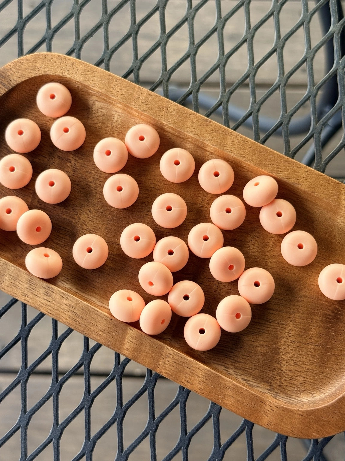 Light peach 14mm abacus silicone spacer beads with matte finish sold in 25 count bags for wristlets, keychains, badge reels, pens, and DIY crafts.