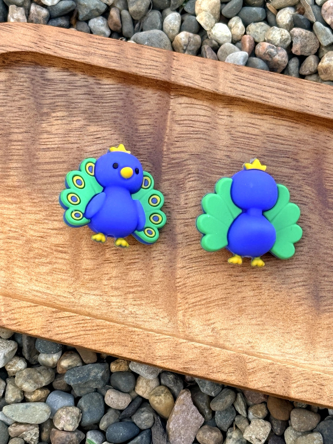 3D peacock silicone focal bead with royal blue body, green feathers, and crown detail for beadable pens, keychains, and DIY crafts