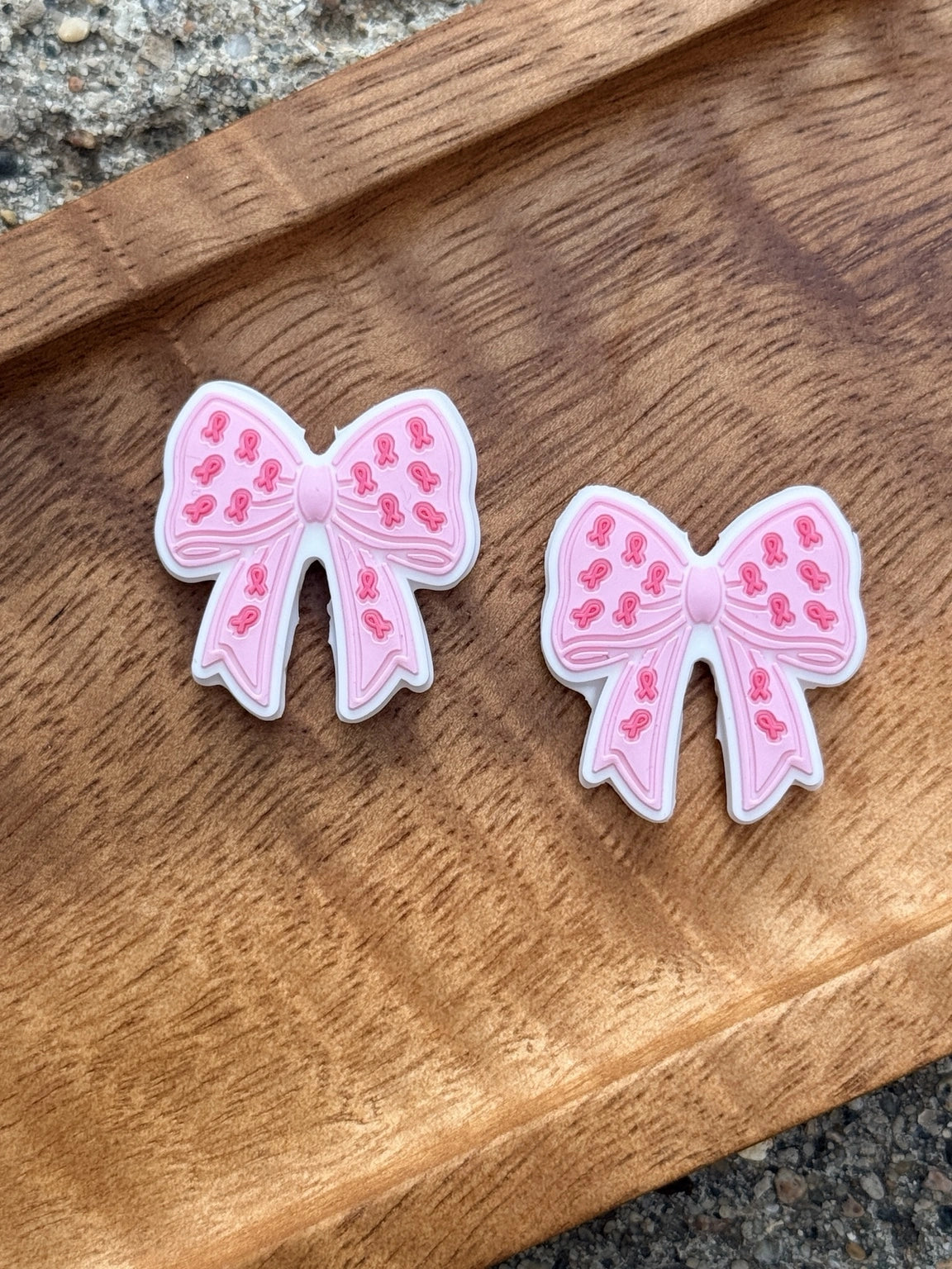 Pink ribbon bow silicone focal bead featuring breast cancer awareness ribbon details for DIY keychains, wristlets, badge reels, beadable pens, and handmade awareness gifts.