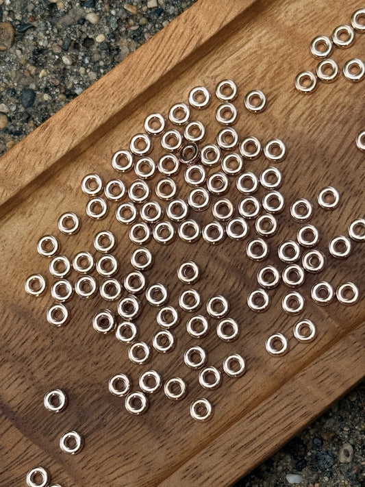 8mm metal ring spacer beads from Four Seasons of Happiness in gold and rose gold finish. Sold in 50-count bags for beadable pens, wristlets, keychains, badge reels, jewelry, and DIY craft projects.