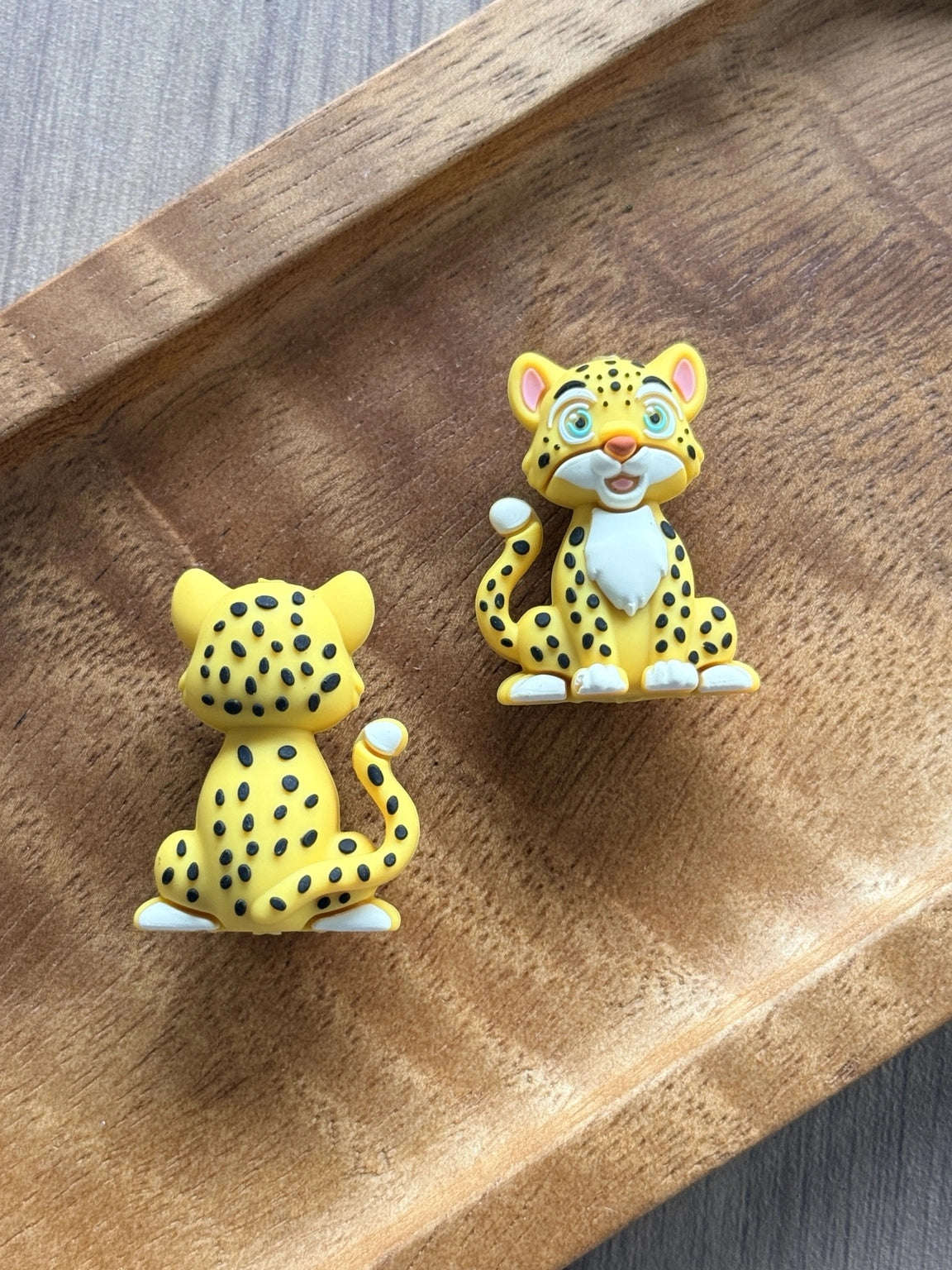 Savannah Smiles 3D silicone cheetah focal bead featuring a cute seated safari animal with bright blue eyes, yellow fur, black spots, and detailed front and back design for DIY bead crafts.