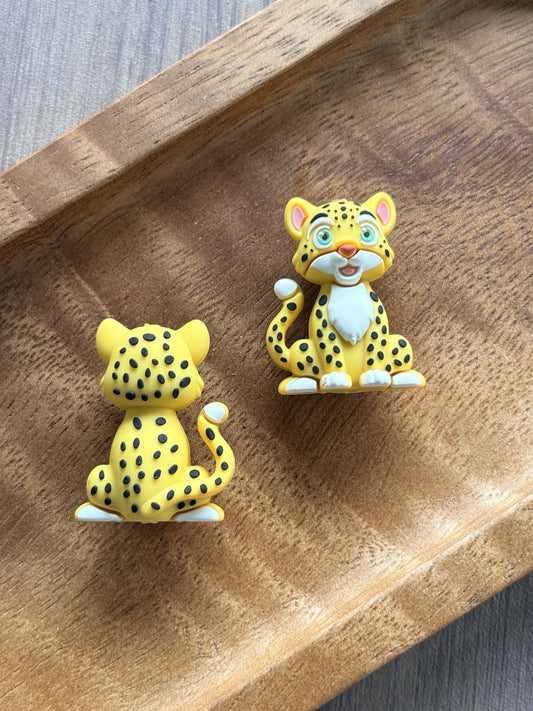 Savannah Smiles 3D silicone cheetah focal bead featuring a cute seated safari animal with bright blue eyes, yellow fur, black spots, and detailed front and back design for DIY bead crafts.