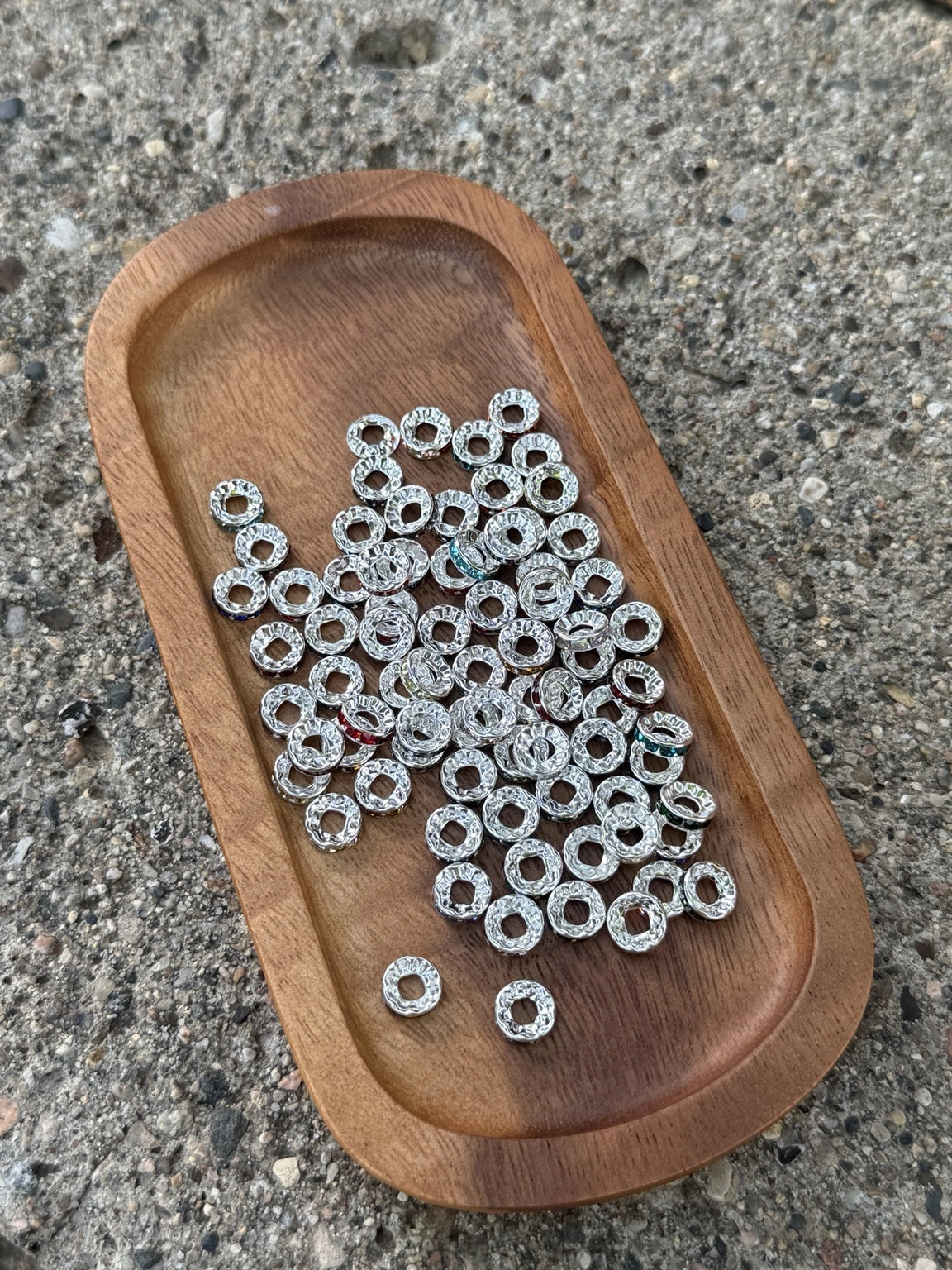 Close-up of premium silver rhinestone spacer beads from Four Seasons of Happiness (FSOH), ideal for separating silicone beads and adding sparkle to beaded pens, keychains, badge reels, wristlets, jewelry, and handmade craft projects.
