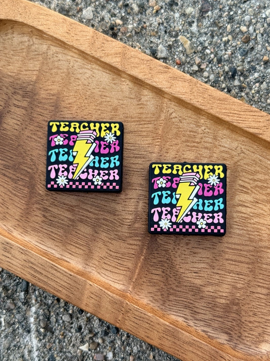 Colorful Teacher Power silicone focal bead with retro teacher lettering, yellow lightning bolt, pencil, flowers, and pink and turquoise accents. Sold individually for teacher-themed DIY crafts.