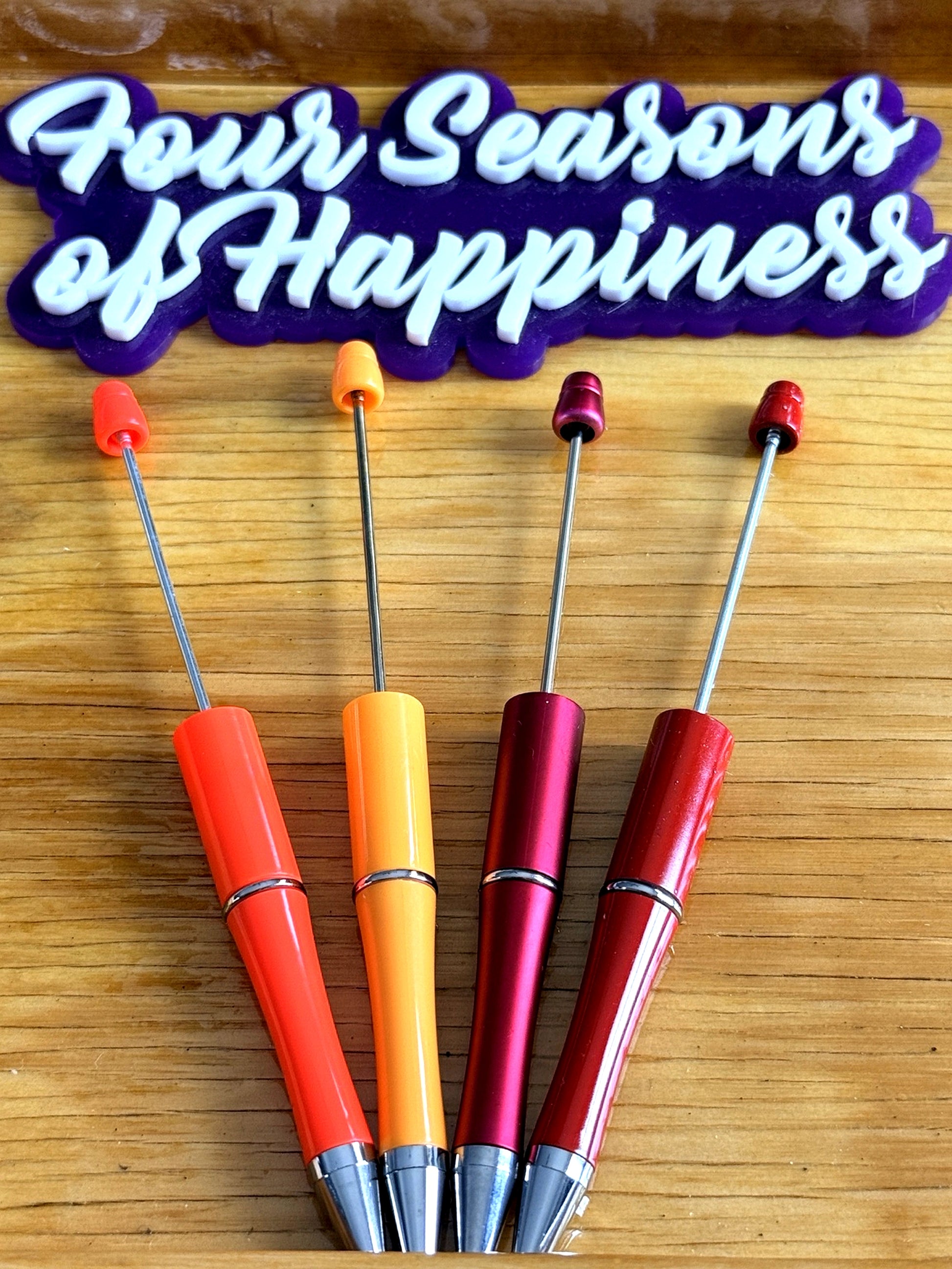 Warm tone beadable pens from Four Seasons of Happiness for DIY beaded pens using silicone beads including red, coral, orange and wine pen bases