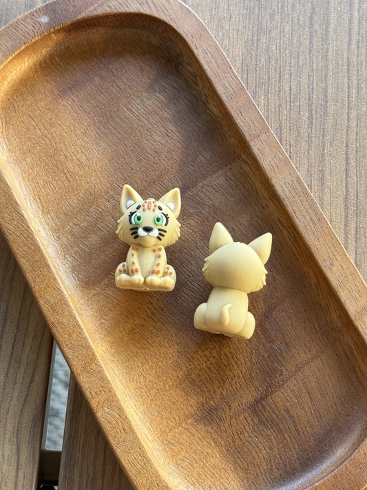 Woodland Whiskers 3D silicone cat focal bead from Four Seasons of Happiness featuring a detailed woodland-inspired kitten with green eyes. Sold individually and perfect for beaded pens, keychains, badge reels, wristlets, jewelry making, and DIY craft projects.