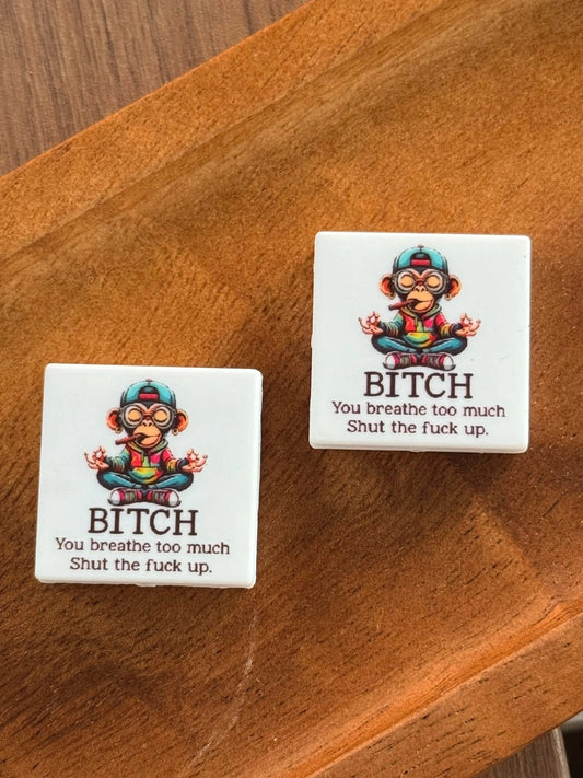 Funny monkey silicone focal bead featuring a humorous quote and colorful monkey design displayed on a wooden tray for beadable pens, keychains, wristlets, badge reels, lanyards, and DIY crafting projects.