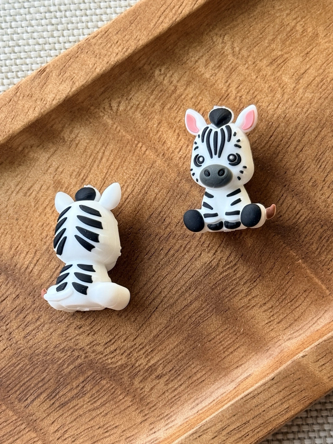 Ziggy Stripes black-and-white 3D silicone zebra focal bead with pink ears, detailed stripes and a seated design for pens, keychains and DIY crafts.