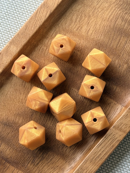 Golden Harvest 14mm silicone hexagon beads with a warm golden-orange pearlescent shimmer, available in 5 or 10 count bags for wristlets, keychains and DIY crafts.