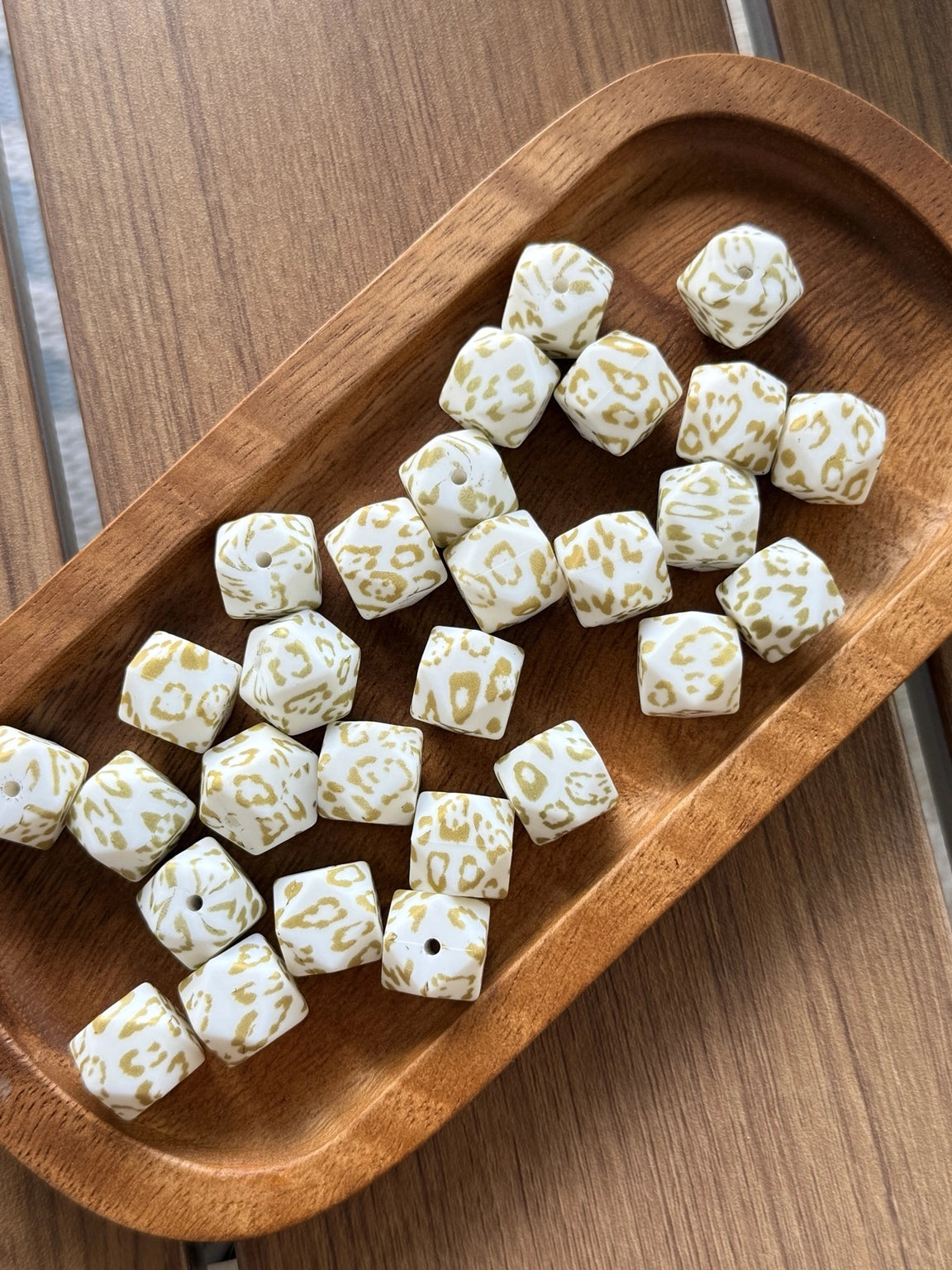 Golden Snow Leopard 14mm printed silicone hexagon beads featuring a white base with gold leopard print design sold in 10 count bags for DIY crafting and beadable projects.