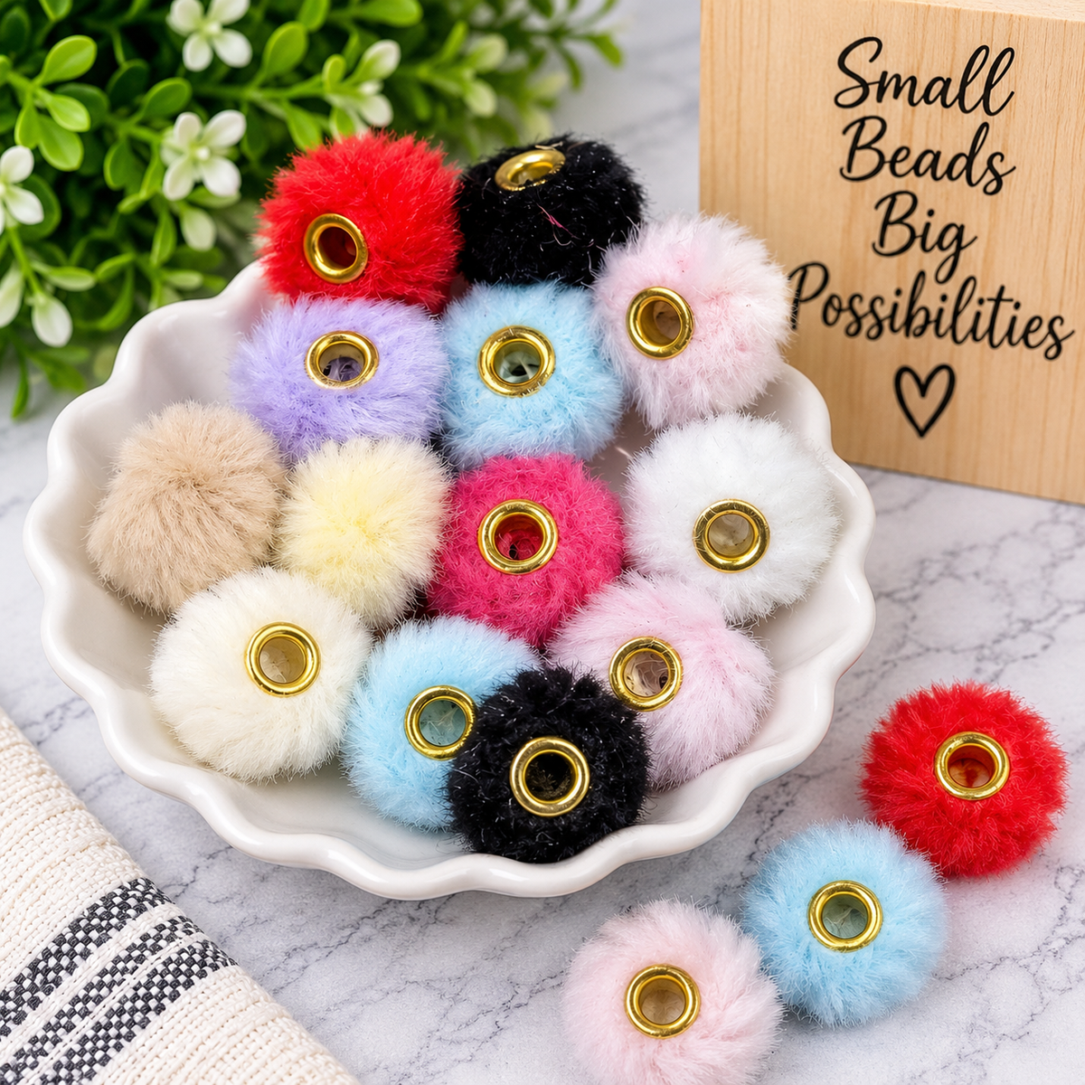 Mixed-color fuzzy pom-pom craft beads featuring soft textured exteriors and gold-tone metal-lined center holes for keychains, bag charms and DIY projects.