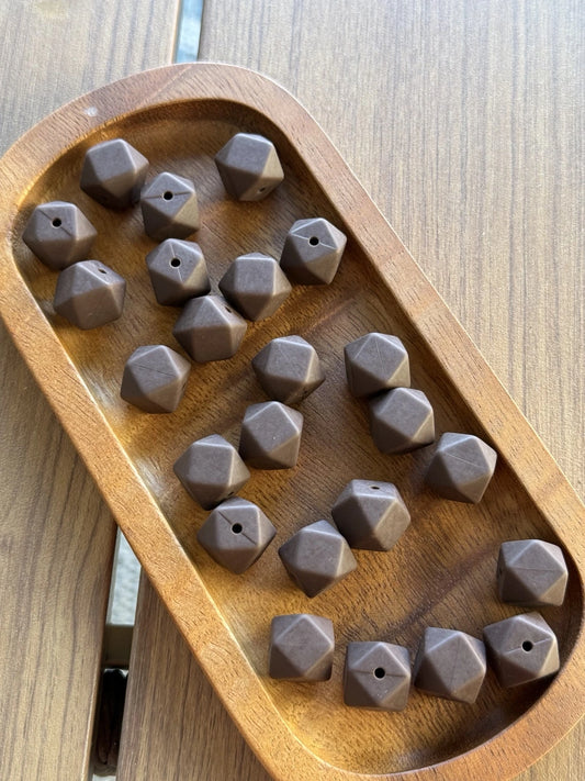 Mocha Bean brown 14mm silicone hexagon beads displayed in a wooden tray, available in 5 or 10 count bags for beadable pens, keychains and DIY crafts.