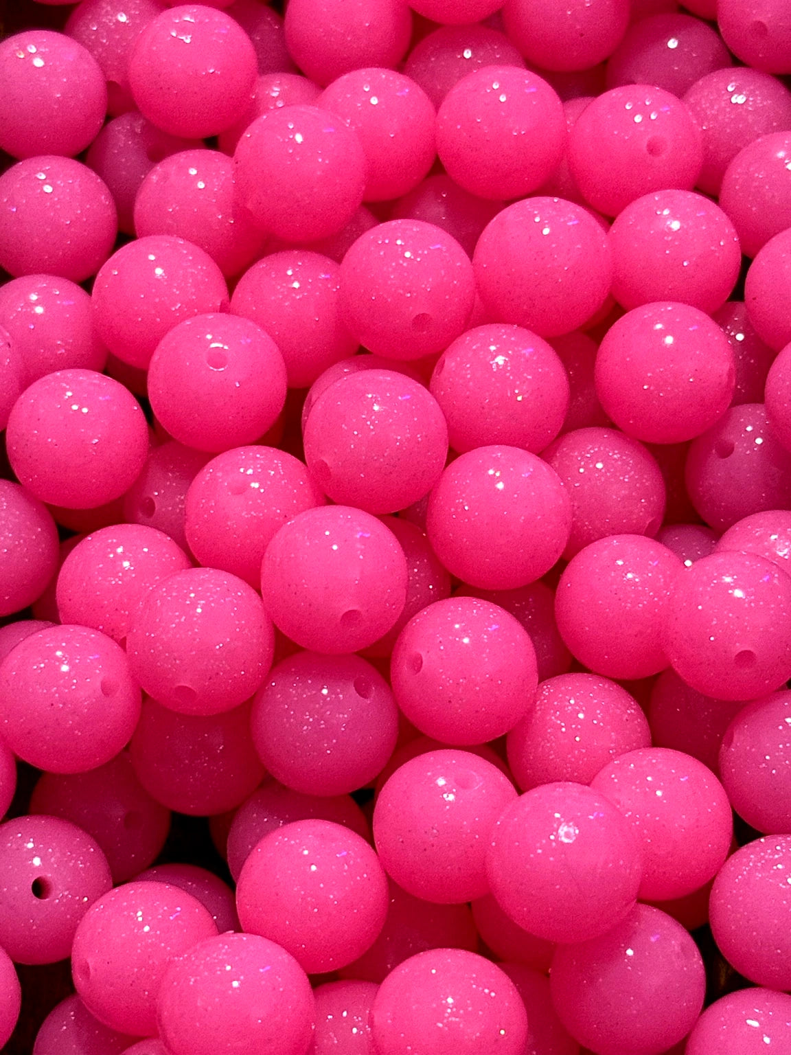 Close-up of pink beads with a sparkling finish