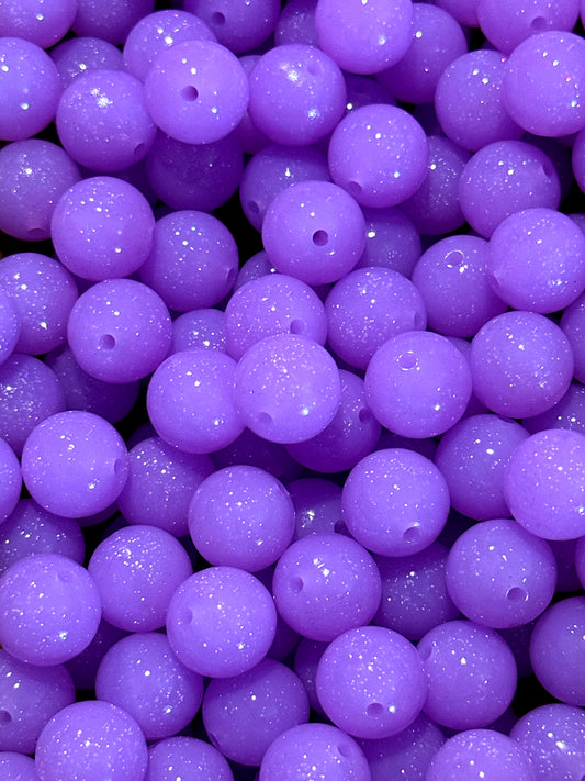 Close-up of purple beads with a glittery texture