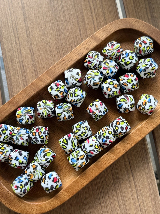 Neon Safari 14mm printed silicone hexagon beads featuring a colorful leopard print pattern for beadable pens, keychains, wristlets, jewelry making, and DIY crafts