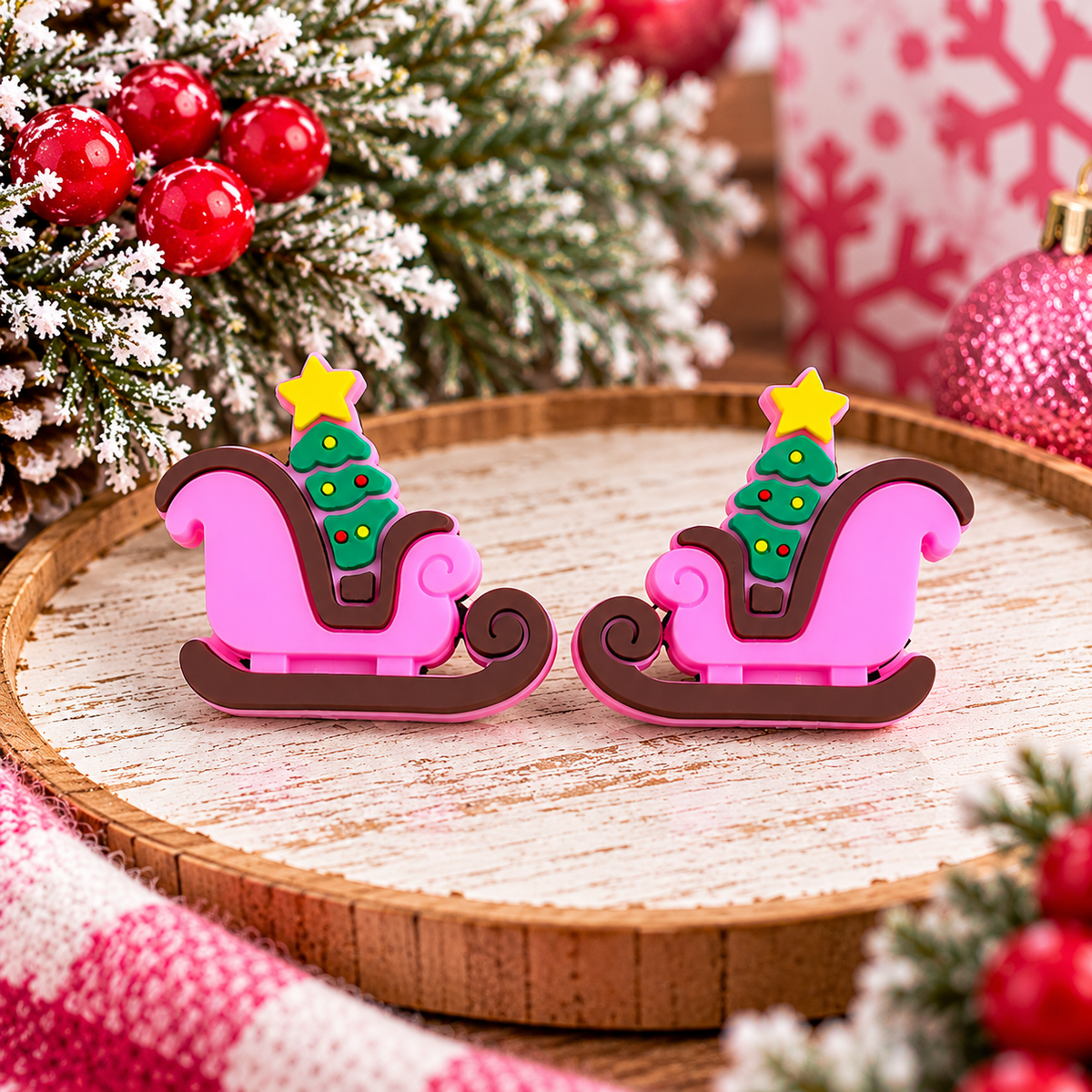 Pink Christmas sleigh silicone focal bead with green decorated tree, yellow star, and brown runners for holiday crafting