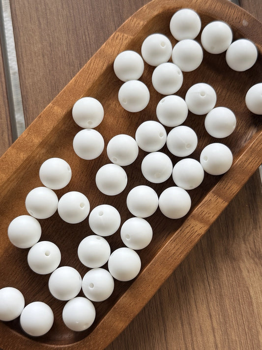 White 15mm matte silicone round beads displayed in a wooden tray for crafting, jewelry making, beadable pens, keychains, and DIY accessories.