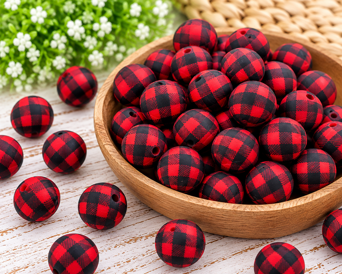 Red Buffalo Check 15mm printed silicone beads featuring a bold red and black plaid pattern displayed in a white bowl.