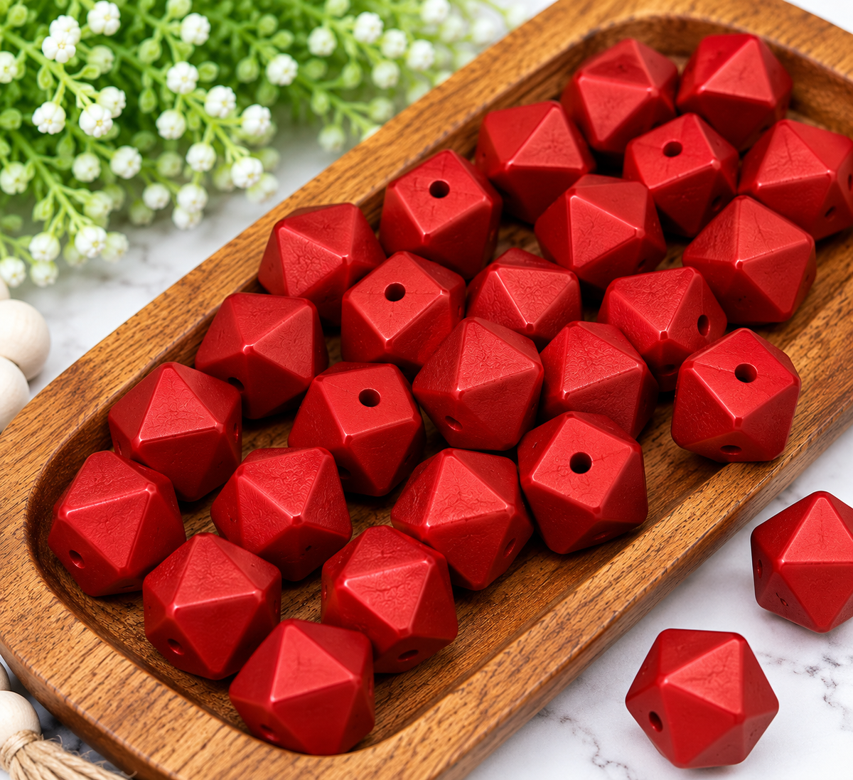 Ruby Radiance 14mm metallic red geometric silicone beads with faceted edges displayed in a wooden tray, sold in 10ct bags