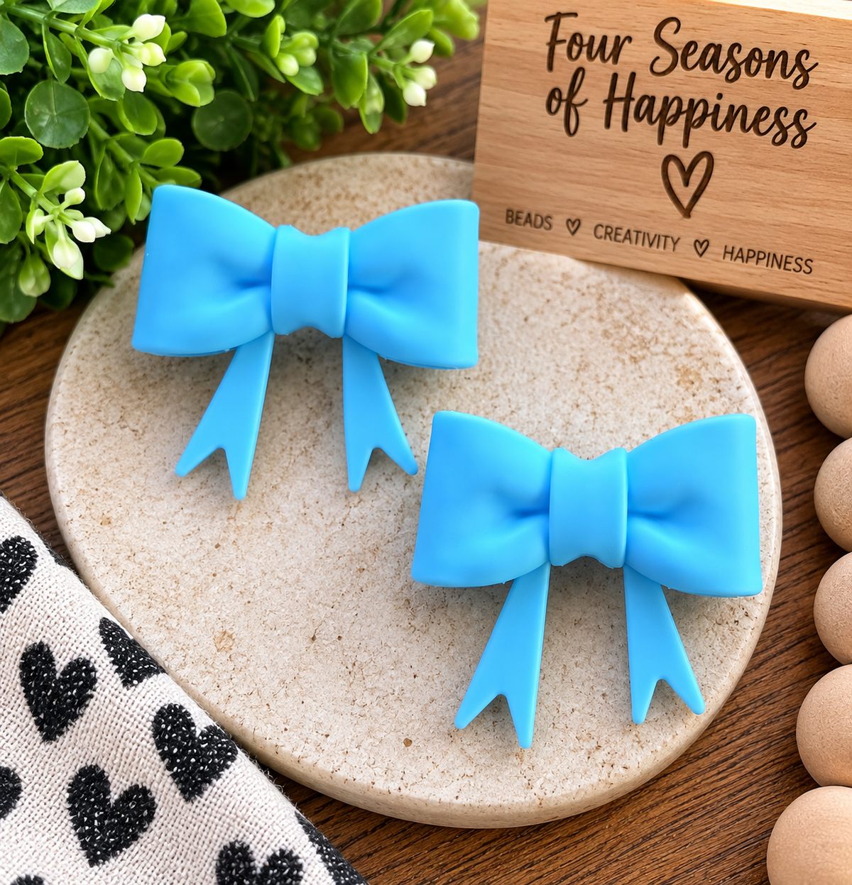 Sky Whisper large blue silicone bow focal bead with ribbon tails, coordinating with FSOH Sky Whisper 15mm silicone beads for wristlet keychains and crafts.