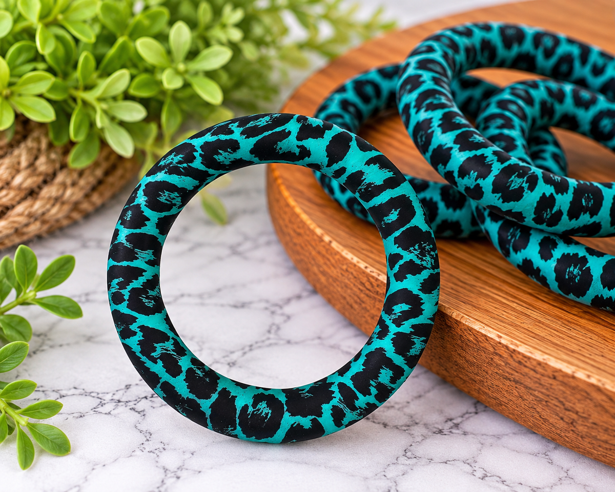 Turquoise Untamed 65mm silicone ring bead featuring a bold turquoise and black animal-inspired print for wristlet keychains and crafts.