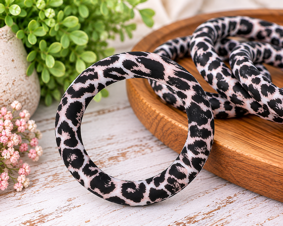Wild Ivory 65mm silicone ring bead with black leopard-inspired print on an ivory background for wristlet keychains and DIY crafts.